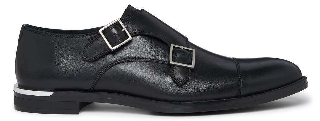 Black leather monk strap shoe on a white background
