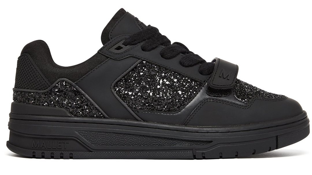 Black trainer with sparkle panels on a white background