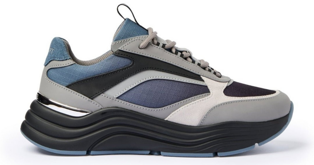 Multicolored sneaker with gray, blue, and black design on a white background