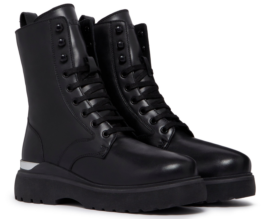black leather lace up boots on a white background